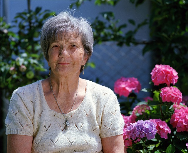 peaceful garden moment with older adult sitting near flowers and vegetables